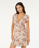 Woman wearing a flora WRAP dress on a white background