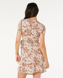 Woman wearing a flora WRAPl dress on a white background