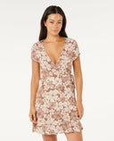 Woman wearing a flora WRAP dress on a white background