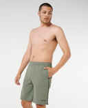 Man wearing green shorts on a plain background