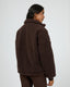 Cozy brown quarter-zip teddy pullover from All About Eve Amara, shown from back view with high collar and relaxed fit