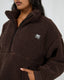 All About Eve Amara Quarter Zip Teddy in brown, cozy sherpa pullover with high collar and front pockets, featuring AAE logo