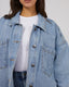 Dale Shacket in light blue denim with chest pockets, curved hem, and button closure, shown over white ribbed top