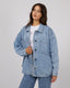Dale Shacket in light blue denim with button front, chest pockets, and relaxed fit worn over white t-shirt