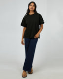 All About Eve Basic Monogram Tee in black, shown on a model with jeans, featuring relaxed fit and crew neckline