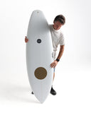 Man holding a white surfboard with a brown circle on a white background