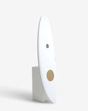 White cylindrical device with a gold circle on a white background