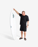 Man holding a white surfboard with 'Alfie' branding on a white background
