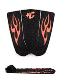 Black surfboard tail pad with red flame designs and a strap on a white background