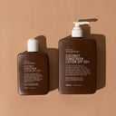 A pump bottle of WE ARE FEEL GOOD COCONUT SUNSCREEN Lotion SPF50+ AND the regular 200ml bottle, with a dark label and coconut scent.